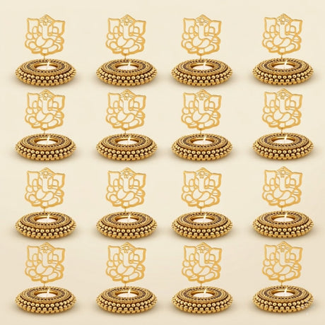 Golden ganesha-themed tealight candle holders with intricate beadwork and ornate detailing for festive home decor