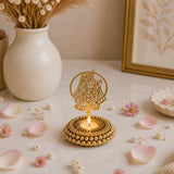 Golden ornate tealight candle holder with intricate couple cutout and beaded base for diwali christmas hanukkah decor
