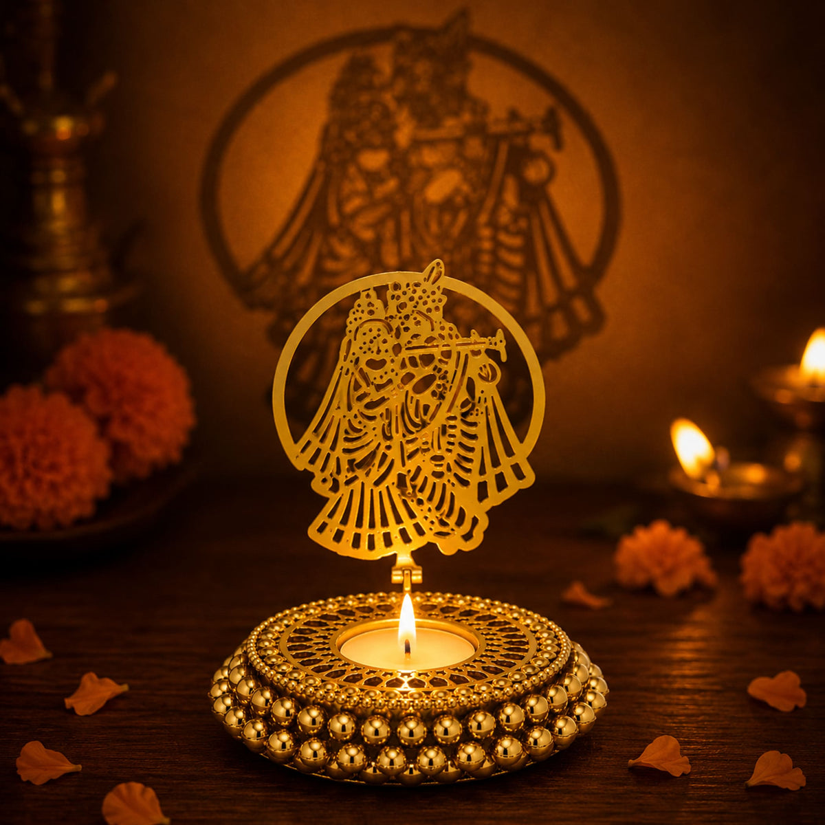Golden ornate ghungroo tea light candle holder with intricate cut-out couple playing music design and filigree patterns