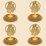 Golden metallic tealight candle holders with intricate couple cut-out designs and beaded bases for festive home decor