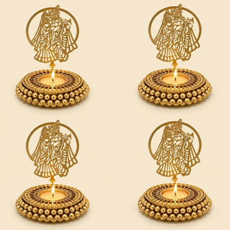 Golden metallic tealight candle holders with intricate couple cut-out designs and beaded bases for festive home decor