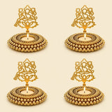 Golden ornate metal tealight candle holders with intricate cut-out designs and beaded edges for festive decor