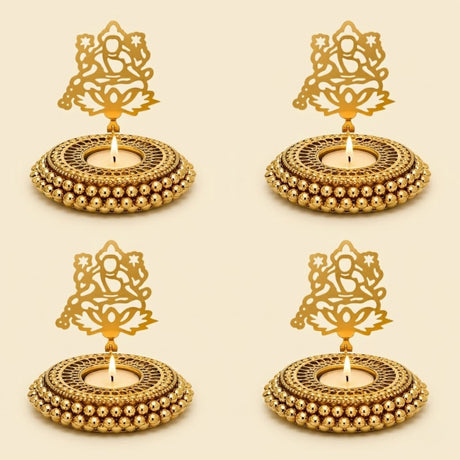 Golden ornate metal tealight candle holders with intricate cut-out designs and beaded edges for festive decor