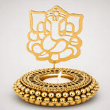 Golden ganesha-themed tealight candle holder with intricate cut-out design and beaded base for festive home decor
