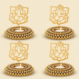Golden ganesha-themed tealight candle holders with intricate cut-out designs and beaded edges for festive decor