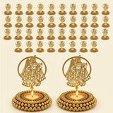 Golden ornate tealight candle holders with intricate lord krishna and radha designs and beaded bases for festive decor