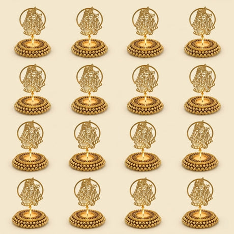 Golden tealight candle holder with intricate couple cut-out designs within circular frames on a beaded base for diwali and festive decor