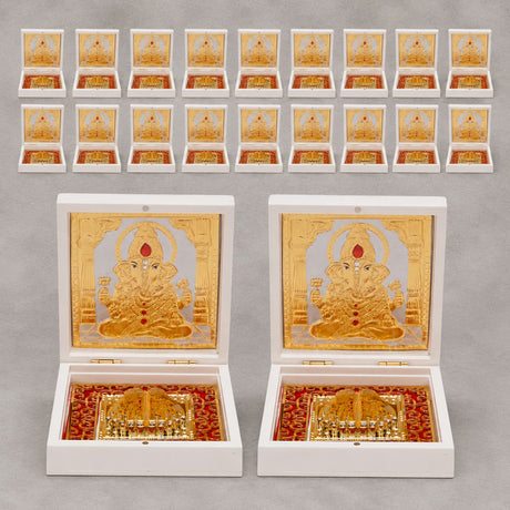 Gold plated ganesh deity figurine in an ornate white box with red lining for home temple and office decor