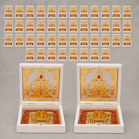 Gold plated ganesh deity figurine set in ornate white boxes with red and gold decorative interiors for home temple and office decor