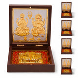 Gold plated laxmi ganesh deity figurines in an ornate dark wood box with red velvet lining for spiritual decor