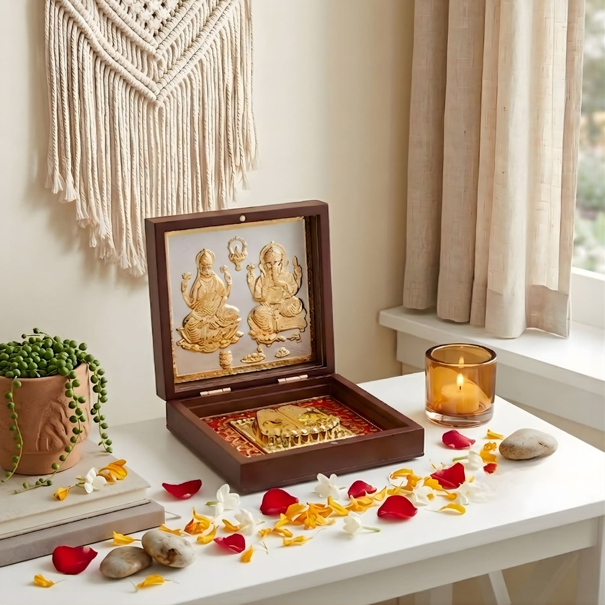 Gold plated laxmi ganesh deity figurines inside an open wooden box with red and gold decorative interior for pooja decor