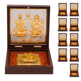 Gold plated laxmi ganesh photo frame with charan paduka featuring golden metallic idols in dark brown wooden box with red velvet lining