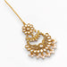 Gold-plated Chand Tikka featuring intricate floral designs, clear stones, and pink pearl jhumkas for traditional weddings