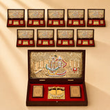 Gold plated radha krishna photo frame with embossed figures in gold set in a dark wooden box with red velvet lining