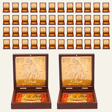 Gold plated radha krishna photo frame with intricate embossed couple design in golden box with red patterned interior