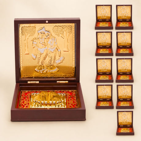 Gold plated radha krishna photo frame with embossed design and red patterned interior for spiritual home decor