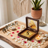 A dark brown wooden gold plated sai baba photo frame with charan paduka and ornate gold interior on rustic tray for pooja