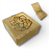 Decorative golden mesh gift box with intricate cut-out ganesha design and beaded edges for festive Indian occasions