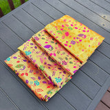 Unstitched golden meenakari blouse piece in vibrant yellow silk with intricate multicolored floral and paisley patterns