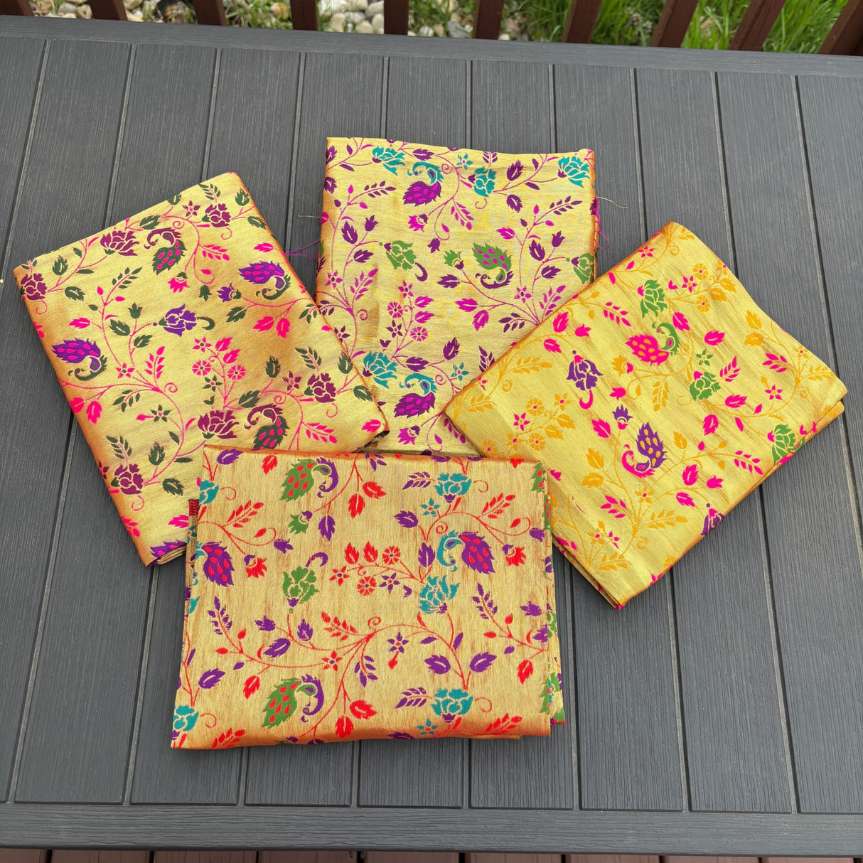 Vibrant yellow silk saree pallu with intricate purple pink green and teal floral paisley patterns in unstitched golden meenakari blouse pieces