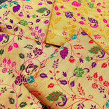 Unstitched golden meenakari blouse piece in vibrant gold silk with intricate multicolored floral and paisley patterns
