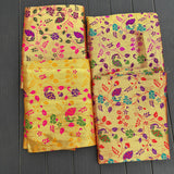Unstitched golden meenakari blouse pieces in vibrant yellow silk with intricate floral and paisley patterns for Indian gifts
