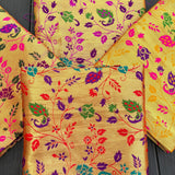 Unstitched golden meenakari blouse piece in vibrant gold brocade with intricate floral and paisley patterns for saree use
