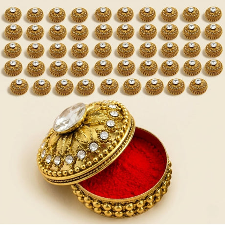 Golden ornate metallic kumkum holder jewelry box with red velvet interior and crystal embellishments for Indian pooja