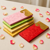 Stacks of colorful money envelopes with decorative golden paisley pattern for indian wedding and cash gifts
