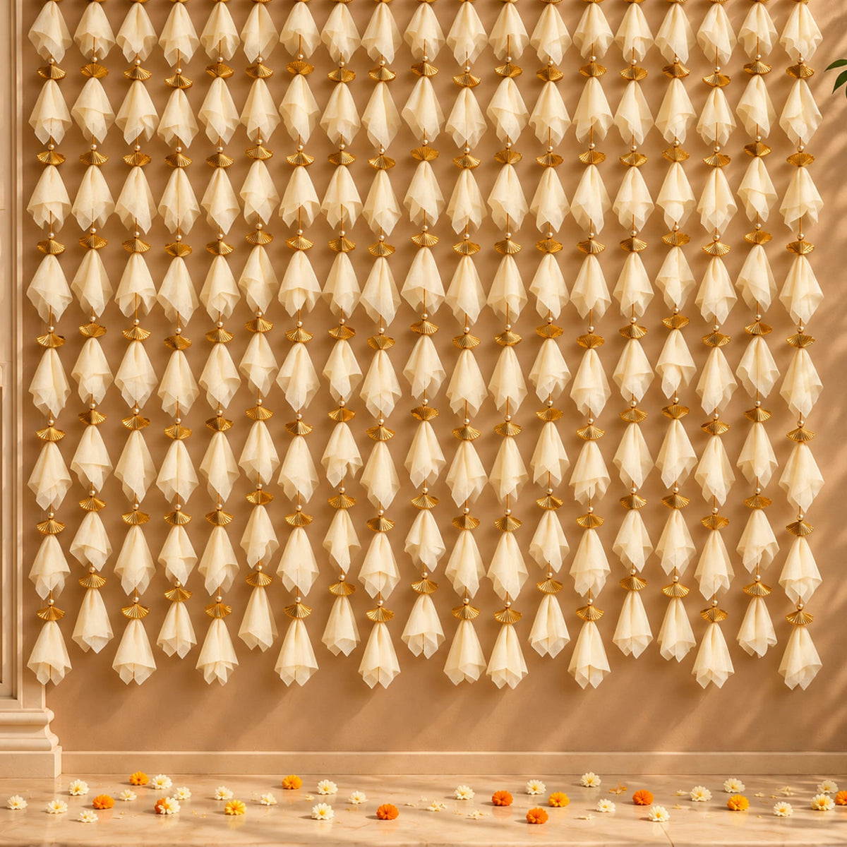 Beige sheer net fabric fans with gold toned metal accents hanging as decorative garland for diwali eid and wedding decor
