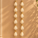 Elegant gold-toned gotta patti net backdrop with cream sheer fabric fans for diwali eid and wedding decor