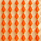 Orange sheer fabric tassels with gold metallic connectors on gotta patti net backdrop for diwali eid and wedding decor