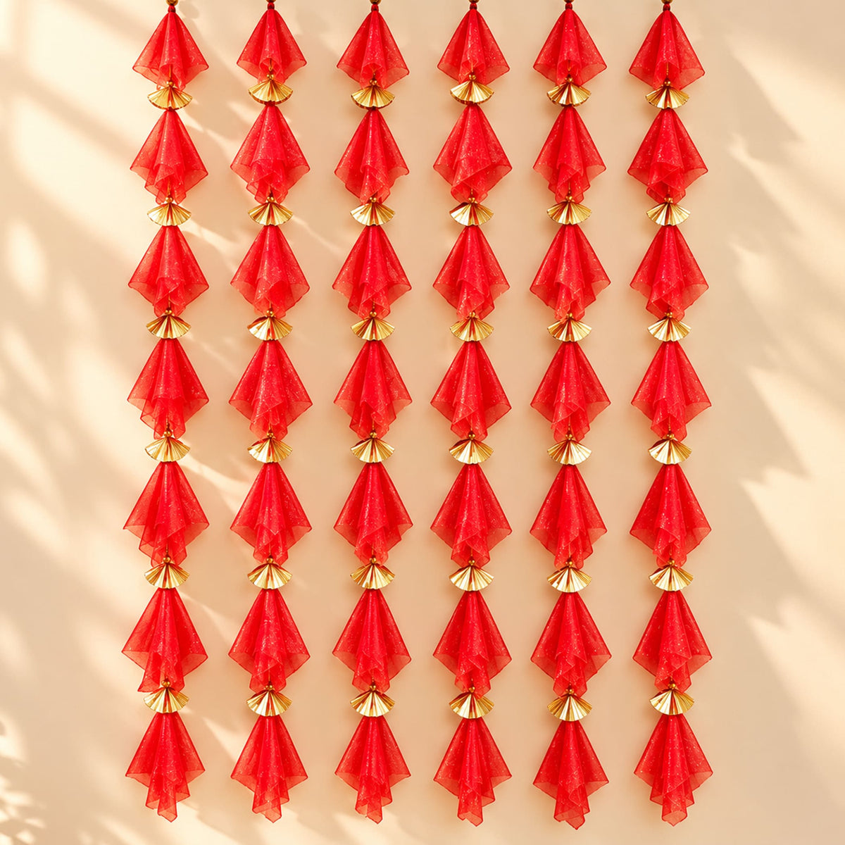 Red sheer fabric gotta patti net backdrop with gold metallic fan connectors for diwali eid and wedding decor