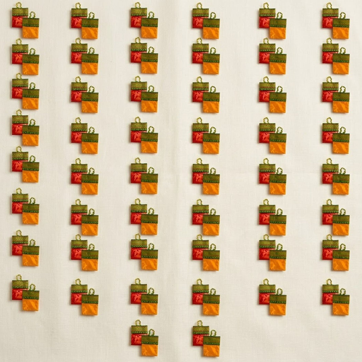 Orange and green gift bag shaped haldi kumkum packets with red ribbon accents for indian wedding and festive use