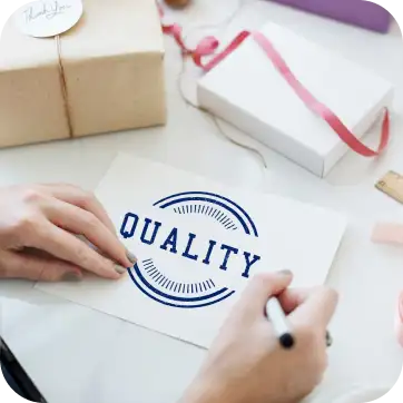 Hand-drawn ’Quality’ logo or stamp design on a white paper.