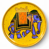 Decorative wooden plate with hand painted vibrant purple elephant and ornate gold green patterns on yellow for wall decor