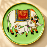 Decorative wooden circular plate hand painted with white cow and calf in red blue gold for boho Indian wall décor