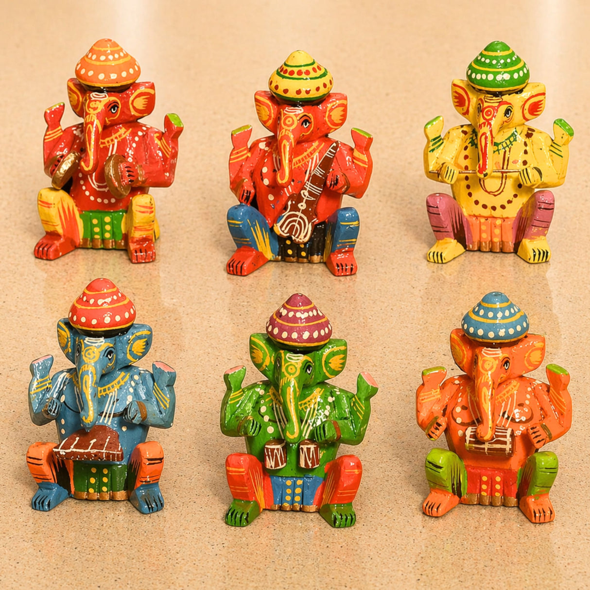 Set of 6 vibrantly painted wooden musician ganesha statues with colorful hats and intricate patterns for good luck