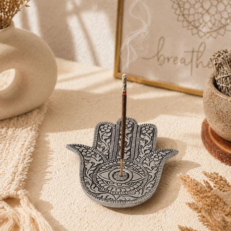 Silver hamsa hand-shaped German silver incense holder with intricate eye and floral patterns for meditation decor