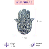 Silver-colored german silver hand-shaped incense stick holder with intricate hamsa design for pooja and meditation room