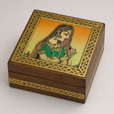 A small wooden jewelry box with gold metal frame and painted woman illustration for decorative storage
