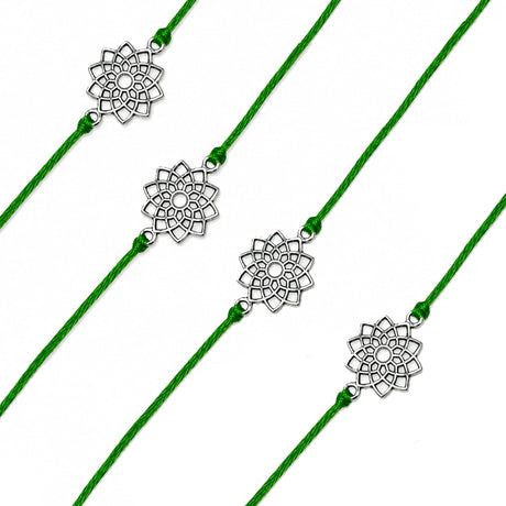 Four green cord designer lotus charm rakhis with silver-toned floral pendants for raksha bandhan protection gift
