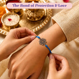 A delicate silver lotus charm on a vibrant blue cord bracelet for raksha bandhan protection and good luck gift
