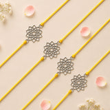 Four silver-toned intricate floral pendant bracelets on vibrant yellow cords designer lotus charm rakhi set for raksha bandhan gift