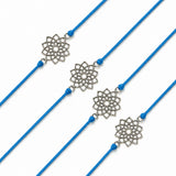 Silver filigree lotus flower charm on vibrant blue cord rakhi bracelet traditional handcrafted gift for brother