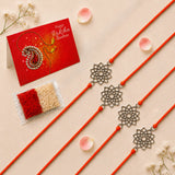 Four orange cord designer lotus charm rakhi with silver filigree lotus pendants handcrafted for raksha bandhan gift