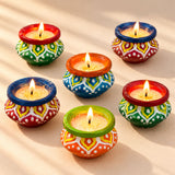 Handmade clay matki diya filled with wax featuring colorful hand-painted geometric patterns for diwali pooja