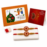 Gold-colored designer rakhi with red beads and central red gemstone in traditional handmade bracelet set for raksha bandhan gift
