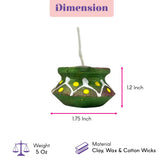 Handmade green ceramic diya candle with yellow and white patterns filled with wax for Diwali pooja and home décor