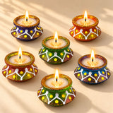 Handmade colorful clay matki diya with glittery gold rims white patterns and yellow dots for diwali pooja and décor